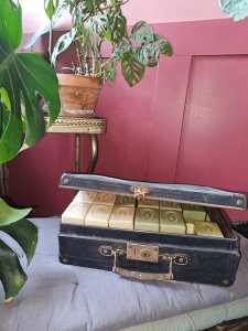 une valisette vintage chinée servant de rangement pour des savons : un upcycling réussi